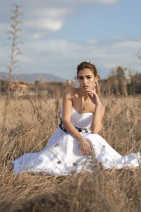 Portrait of woman sitting on field