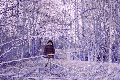 Man walking with mask on snow covered land