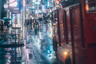 People in illuminated city at night