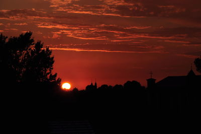 Silhouette trees against sky during sunset