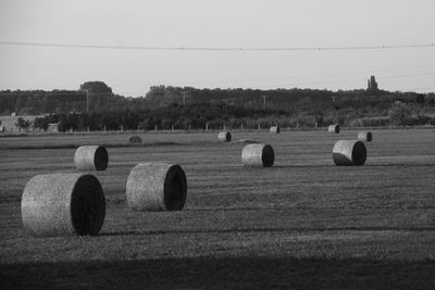 Hay bales on field against sky