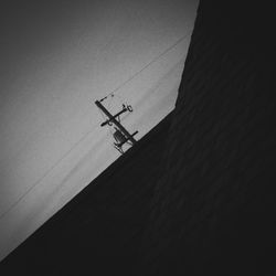 Low angle view of silhouette airplane against sky