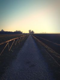 Road against clear sky during sunset