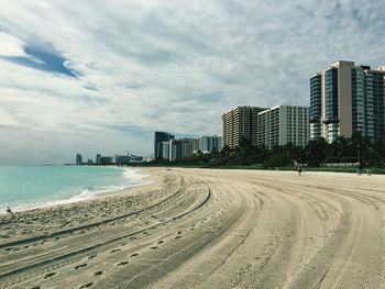 View of beach against cloudy sky