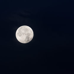 Low angle view of moon against clear sky at night