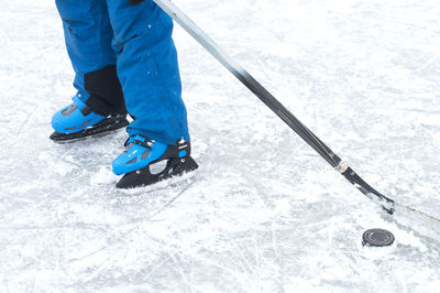 Low section of man playing ice hockey