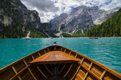 Boat sailing on lake against mountain