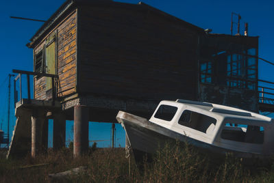 Abandoned building at beach against sky