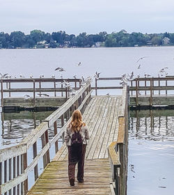 Pier on lake against clear sky