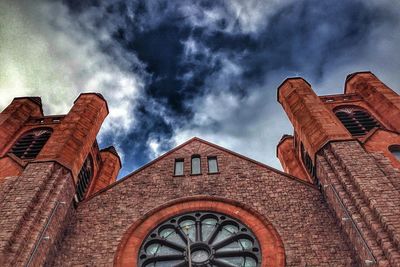 Low angle view of building against cloudy sky