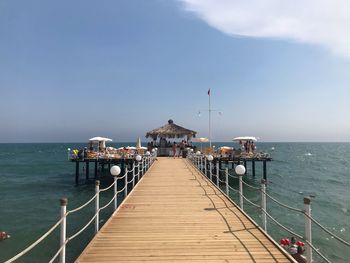 Pier over sea against sky