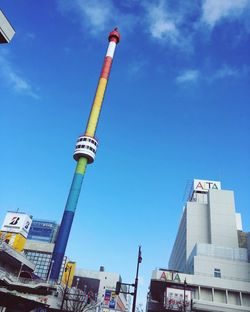 Low angle view of communications tower against blue sky