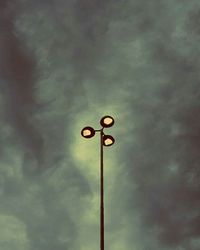 Low angle view of street light against cloudy sky