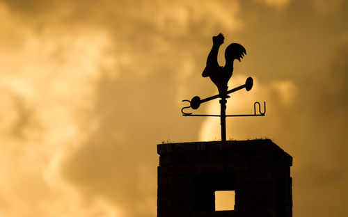 Weather vane at sunset