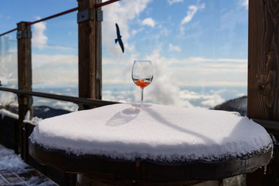 Close-up of ice cream on table against sky during winter