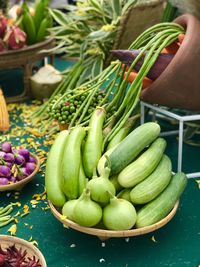 Green fruits for sale at market stall