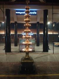 Low angle view of illuminated lights hanging on ceiling in building