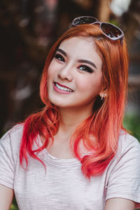 Close-up portrait of smiling young woman