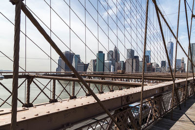 Low angle view of suspension bridge against sky