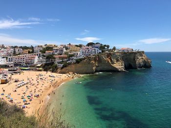 High angle view of sea and buildings against sky