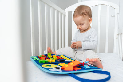 High angle view of boy playing with toys at home