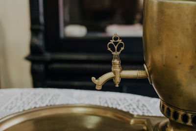 Russian samovar on a table with a tablecloth, against the background of a pantry