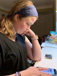 Side view of teenage girl looking at home