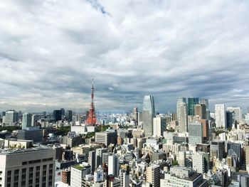 View of cityscape against cloudy sky