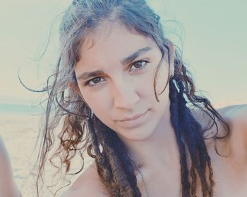 Close-up portrait of young woman at beach