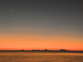 Scenic view of sea against romantic sky at sunset