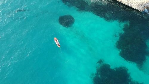 High angle view of people swimming in sea