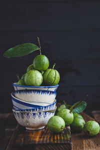 Close-up of fruits on table against black background