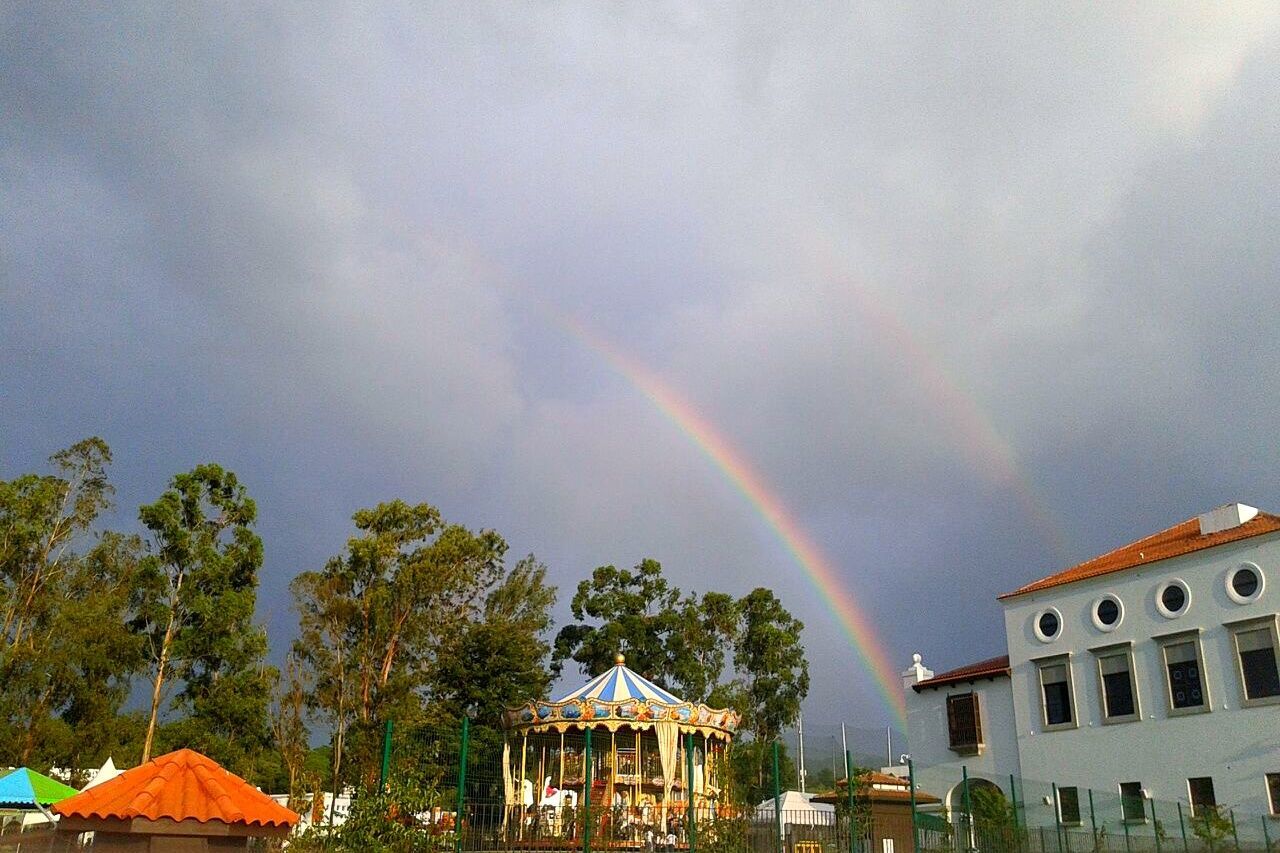 building exterior, rainbow, architecture, built structure, house, sky, tree, residential structure, residential building, multi colored, cloud - sky, weather, cloudy, nature, outdoors, residential district, beauty in nature, no people, day, overcast, cloud, scenics, growth, green color, high section, idyllic, tranquility