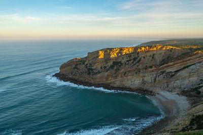 Sea cliffs landscape in cabo espichel at sunset, in portugal