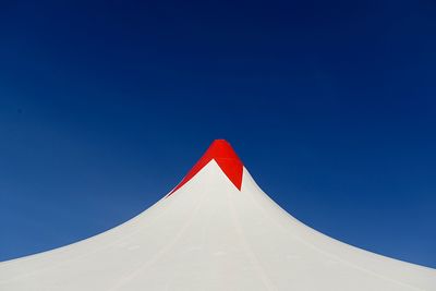 Low angle view of flag against clear blue sky