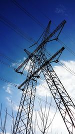 Low angle view of electricity pylon against sky