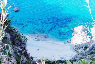 High angle view of rocks by sea