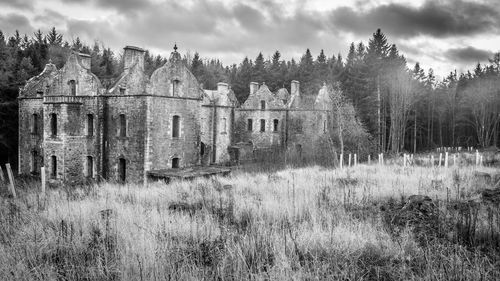 Panoramic shot of old house on field against sky