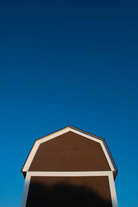 Low angle view of building against clear blue sky