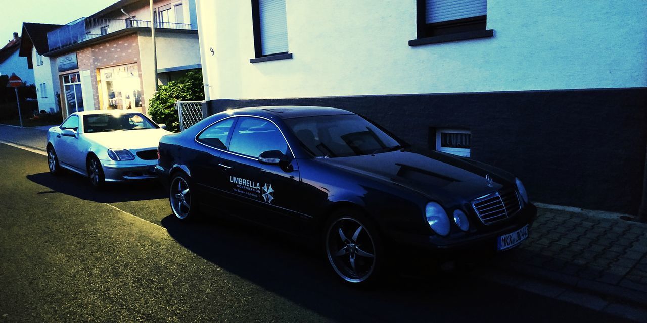 CAR PARKED ON STREET BY BUILDING