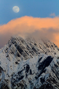 Scenic view of snowcapped mountains against sky during sunset