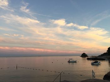 Scenic view of calm sea against cloudy sky