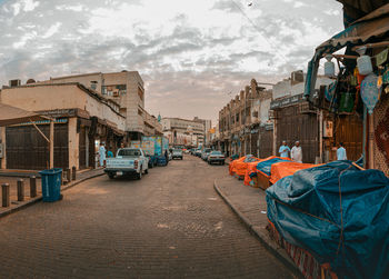 Street amidst buildings in city against sky