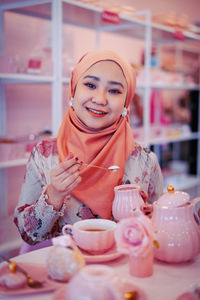 Portrait of a smiling young woman with ice cream