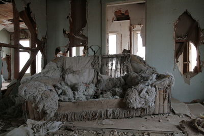 Messy sofa in abandoned house