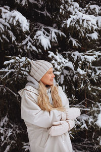 Portrait of a young girl in the winter in the forest