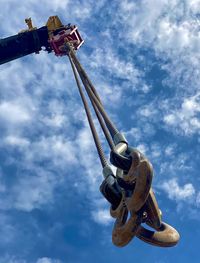 Low angle view of crane against sky