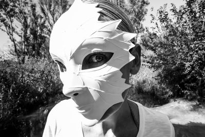 Close-up portrait of young woman wearing mask