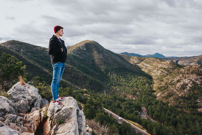 Man standing on mountain against sky