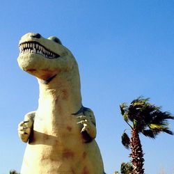 Low angle view of statue against clear blue sky